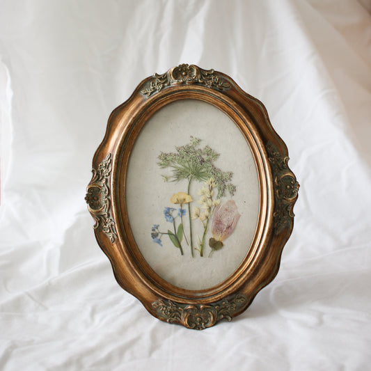Oval frame with pressed wildflowers